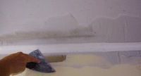skimming joint compound on an inside drywall corner