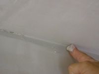 spreading joint compound at the corner crease