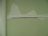 clearing debris from a plaster crack