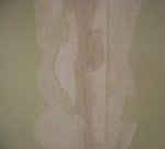 covering the caulked  crack with joint compound