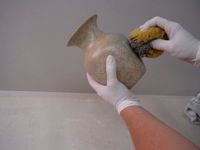 applying a first glaze coat to a glass flower vase