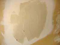 applying joint compound over the wall patch
