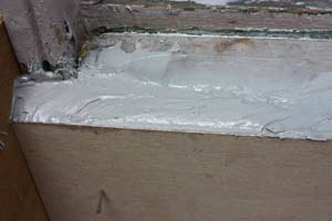 photo epoxy filler in a form around a rotted windowsill