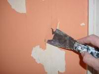 scraped water damage on a plaster wall