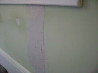 applying joint compound over damaged drywall tape