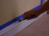 painting white trim molding with masking tape