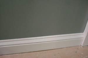 photo of a painted baseboard molding and wall