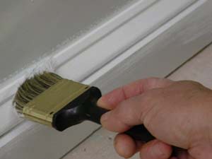 photo painting a baseboard next to a wall