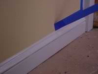 pulling masking tape off a wall