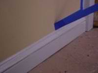 removing masking tape to leave a straight line on molding