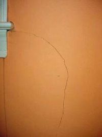 removing loose material from a wall crack