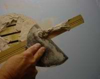 skimming excess compound to repair plaster damage