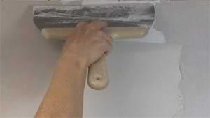 photo applying a second coat of joint compound over a drywall butt joint