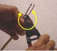 photo using wire strippers to remove electrical wire insulation