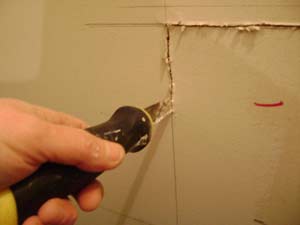 photo cutting out drywall with a saw