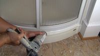 photo demonstrating how to apply caulk around a shower stall photo demonstrating how to apply caulk around a shower stall