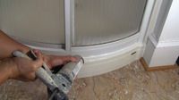 photo demonstrating how to apply caulk around a shower stall