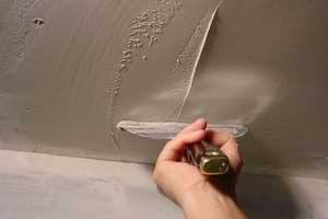 photo spreading a third coat of joint compound over an aluminum patch photo spreading a third coat of joint compound over an aluminum patch