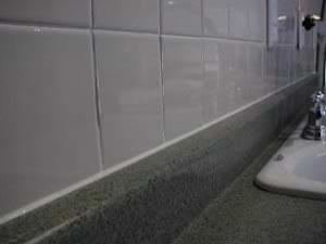 photo of a caulked crack behind a countertop photo of a caulked crack behind a countertop