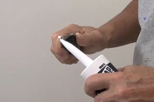 photo demonstrating how to cut the tip off a caulk tube photo demonstrating how to cut the tip off a caulk tube