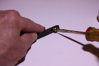photo driving a brass screw into a door handle spindle to cut new threads photo driving a brass screw into a door handle spindle to cut new threads