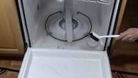 photo of a brush cleaning crevices inside a dishwasher photo of a brush cleaning crevices inside a dishwasher