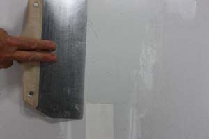 photo applying a second coat of joint compound over a drywall seam photo applying a second coat of joint compound over a drywall seam