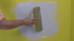 photo smoothing a second coat of joint compound over a drywall patch photo smoothing a second coat of joint compound over a drywall patch