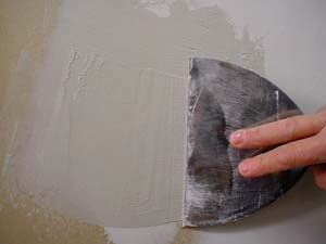 photo applying a second coat of joint compound over a patch photo applying a second coat of joint compound over a patch