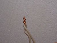 photo of two wires spliced together with a clockwise twist photo of two wires spliced together with a clockwise twist