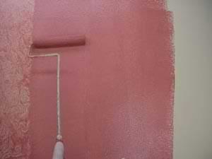 photo rolling a second coat of painting glaze onto a wall photo rolling a second coat of painting glaze onto a wall