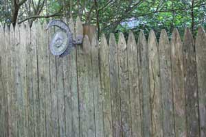 photo of stockade fence sections coming together at a post