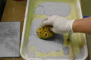 photo demonstrating how to load a sponge with painting glaze to apply a stone faux finish photo demonstrating how to load a sponge with painting glaze to apply a stone faux finish