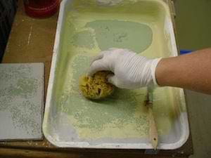 photo demonstrating using a paint tray to prepare a sponge for painting photo demonstrating using a paint tray to prepare a sponge for painting