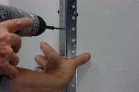 photo hand installing metal drywall corner bead
