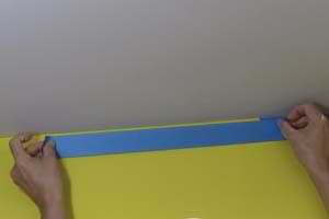 photo masking a ceiling with tape along a wall photo masking a ceiling with tape along a wall