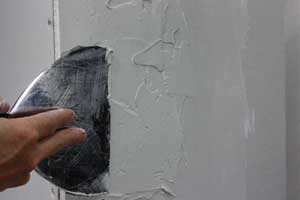 photo applying joint compound to a drywall corner photo applying joint compound to a drywall corner