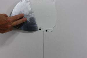photo applying a first coat of mud to a drywall seam photo applying a first coat of mud to a drywall seam