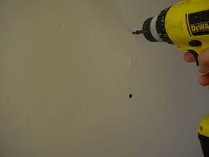 driving screws on both side of a nail pop photo driving screws on both sides of a nail pop
