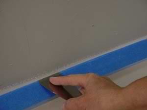 photo masking a baseboard next to a wall