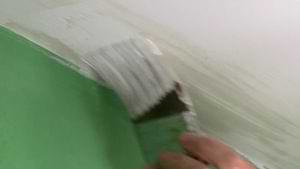 brushing paint on a ceiling with a forward stroke