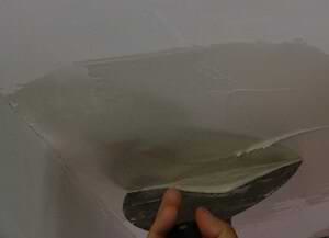 photo smoothing a second coat of joint compound over an aluminum patch photo smoothing a second coat of joint compound over an aluminum patch