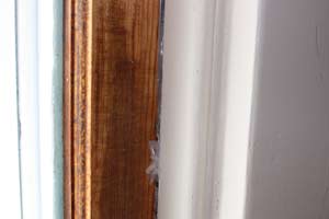 photo of plastic wrap tucked between window sash and jamb