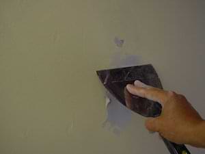 photo demonstrating how to push joint compound into a wall hole photo demonstrating how to push joint compound into a wall hole