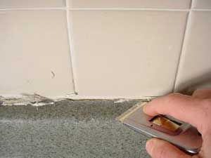 photo cutting away cracked caulk from a countertop photo cutting away cracked caulk from a countertop