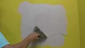 photo applying joint compound over a drywall patch photo applying joint compound over a drywall patch