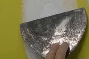 photo using a joint knife to smooth out drywall paper fibers photo using a joint knife to smooth out drywall paper fibers