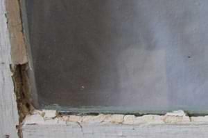 photo of old loose and cracked window glazing photo of old loose and cracked window glazing